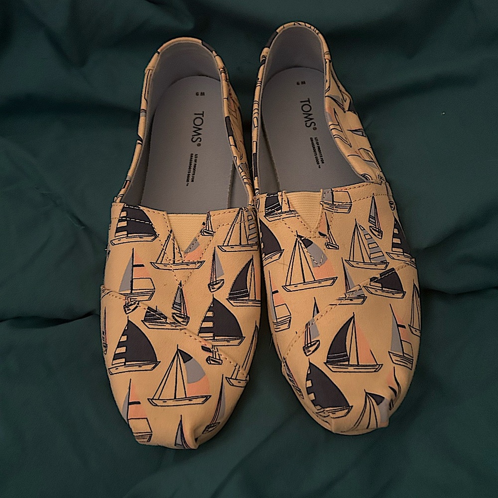 Tan, light blue, pink, and navy sailboat Tom’s. Women’s size 9.